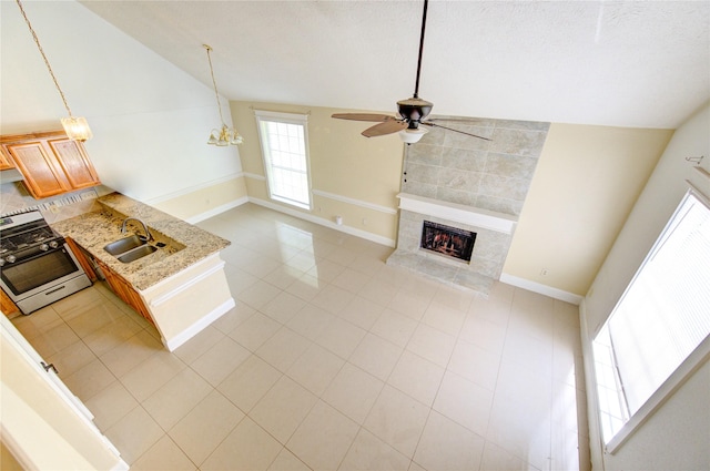 2815 Lakefield Way, Sugar Land, TX 77479 - unfurnished living room with a sink, vaulted ceiling, ceiling fan, a fireplace, and baseboards