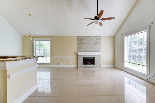 2815 Lakefield Way, Sugar Land, TX 77479 - unfurnished living room featuring vaulted ceiling, a fireplace, a ceiling fan, light tile patterned floors, and baseboards