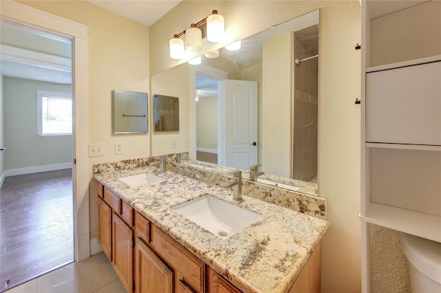 2815 Lakefield Way, Sugar Land, TX 77479 - full bath with double vanity, tile patterned floors, and baseboards