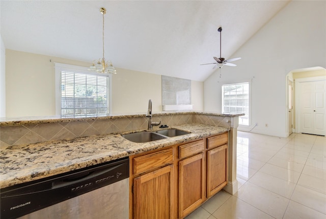 2815 Lakefield Way, Sugar Land, TX 77479 - kitchen featuring stainless steel dishwasher, a sink, light stone counters, plenty of natural light, and high vaulted ceiling