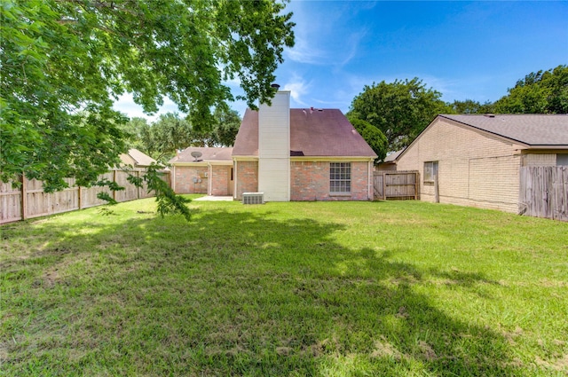 2815 Lakefield Way, Sugar Land, TX 77479 - rear view of house with a chimney and brick siding