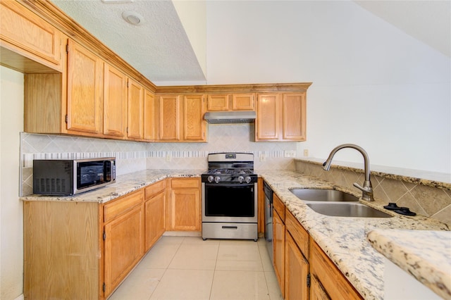 2815 Lakefield Way, Sugar Land, TX 77479 - kitchen featuring stainless steel appliances, a sink, under cabinet range hood, light stone counters, and backsplash