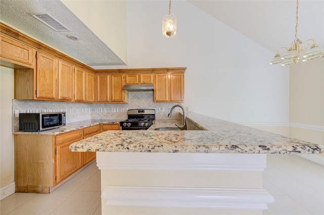 2815 Lakefield Way, Sugar Land, TX 77479 - kitchen featuring appliances with stainless steel finishes, a sink, under cabinet range hood, light tile patterned flooring, and backsplash