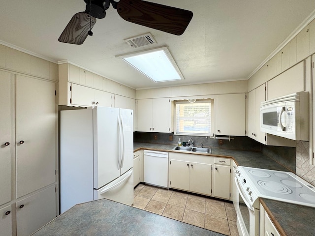 121 Briar Ln, Crockett, TX 75835 - kitchen with white appliances, a sink, dark countertops, crown molding, and light tile patterned floors