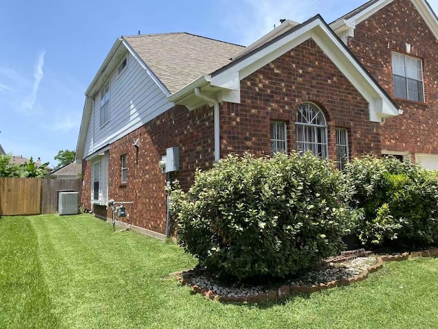 11830 Meadow Place Dr, Houston, TX 77071 - view of side of home with brick siding, roof with shingles, and central AC unit