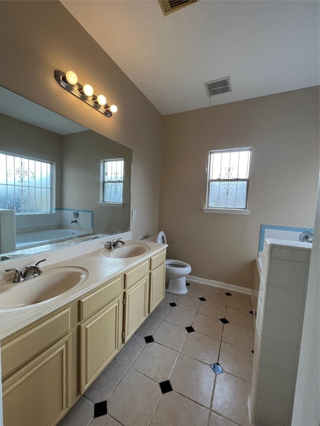 11830 Meadow Place Dr, Houston, TX 77071 - bathroom with a garden tub, tile patterned flooring, toilet, double vanity, and baseboards
