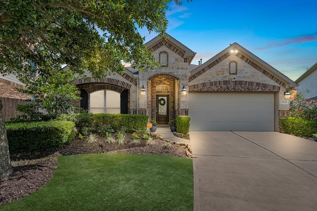 20735 Cactus Lake Ln, Richmond, TX 77407 - view of front of property with stone siding, driveway, a garage, a front lawn, and brick siding