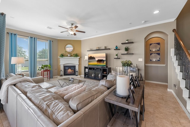 20735 Cactus Lake Ln, Richmond, TX 77407 - living room featuring ceiling fan, stairway, crown molding, a glass covered fireplace, and baseboards