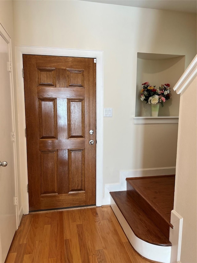 3727 Main Poplar Dr, Houston, TX 77025 - foyer entrance featuring light wood-style flooring, stairway, and baseboards