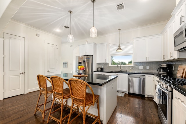 829 Wakefield Dr Unit A, Houston, TX 77018 - kitchen with stainless steel appliances, dark countertops, a sink, recessed lighting, and backsplash