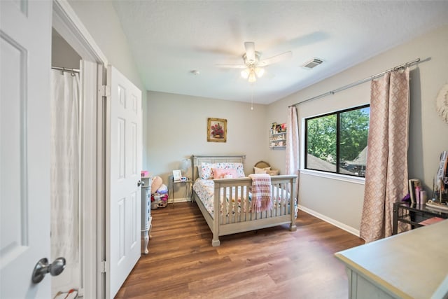bedroom featuring baseboards, wood finished floors, and ceiling fan