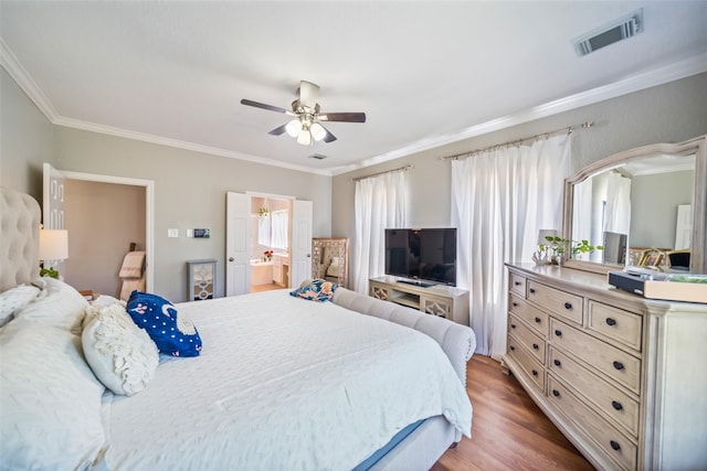 bedroom featuring crown molding, wood finished floors, ceiling fan, and ensuite bathroom