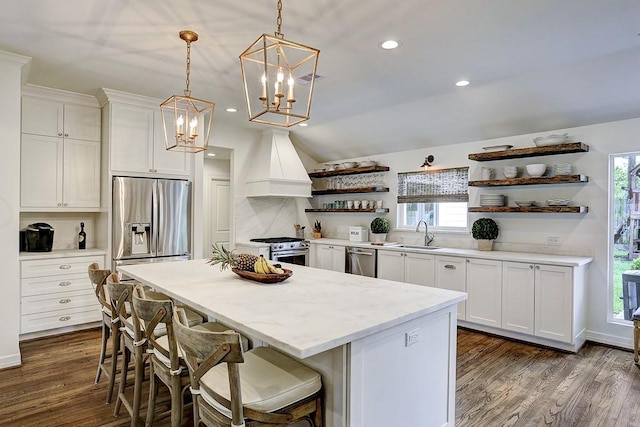 5326 Windswept Ln, Houston, TX 77056 - kitchen featuring open shelves, appliances with stainless steel finishes, custom exhaust hood, a chandelier, and a center island