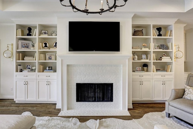 5326 Windswept Ln, Houston, TX 77056 - living room featuring dark wood-type flooring, a fireplace, a chandelier, and ornamental molding