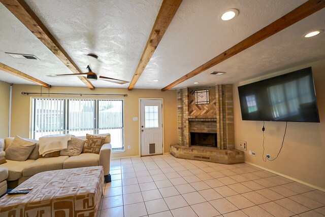18907 Oak Bower Dr, Humble, TX 77346 - living room with light tile patterned floors, beamed ceiling, baseboards, a fireplace, and a textured ceiling