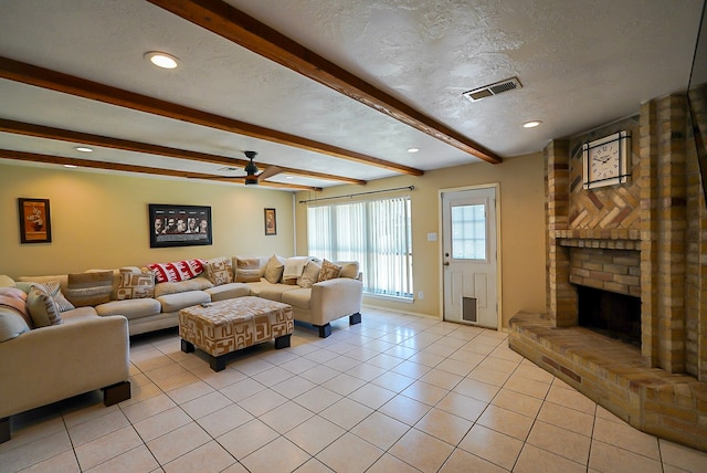 18907 Oak Bower Dr, Humble, TX 77346 - living room featuring beam ceiling, a ceiling fan, a textured ceiling, a fireplace, and light tile patterned flooring