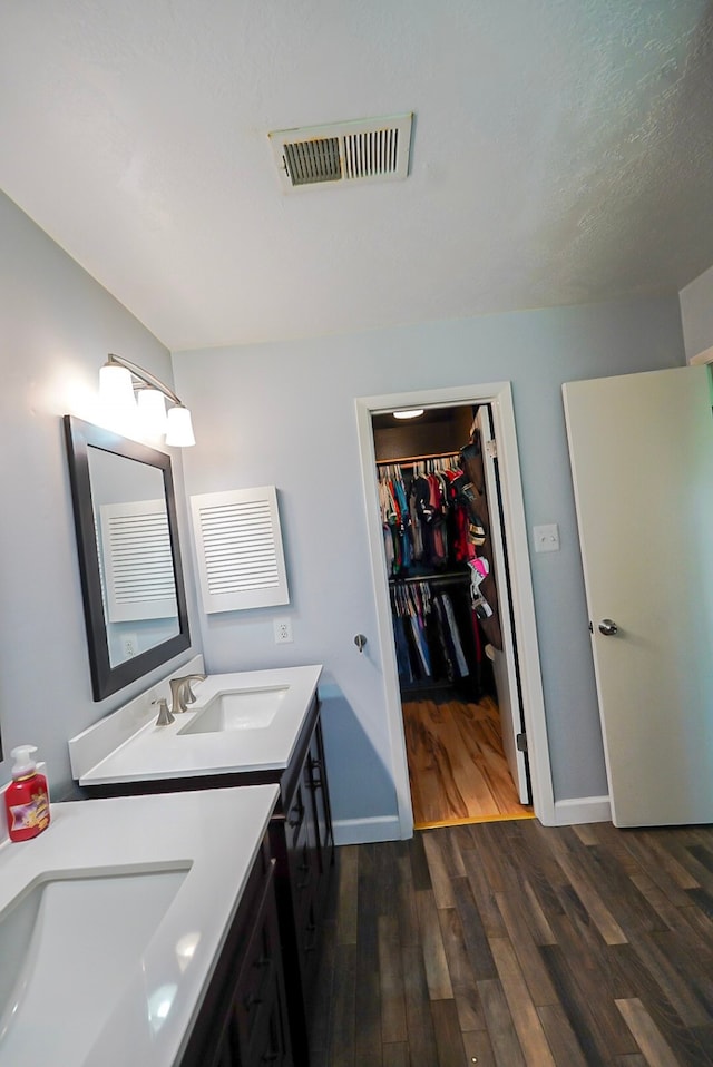 18907 Oak Bower Dr, Humble, TX 77346 - bathroom featuring wood finished floors, baseboards, vanity, and a spacious closet