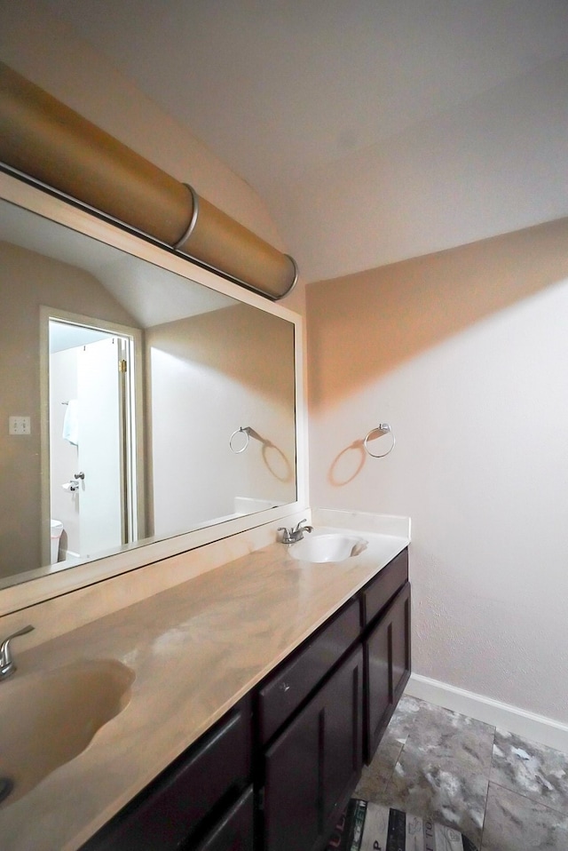 18907 Oak Bower Dr, Humble, TX 77346 - full bath with double vanity, baseboards, toilet, and lofted ceiling