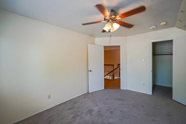 18907 Oak Bower Dr, Humble, TX 77346 - unfurnished bedroom featuring carpet floors, a ceiling fan, a walk in closet, and baseboards