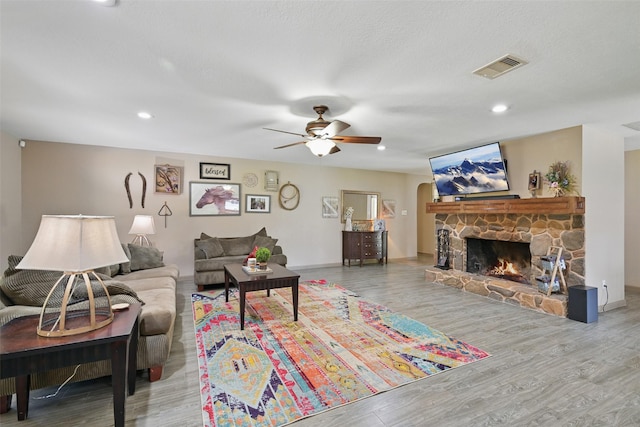 13111 Oak Plaza Dr, Cypress, TX 77429 - living room featuring a ceiling fan, wood finished floors, a stone fireplace, baseboards, and recessed lighting