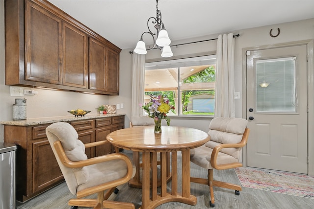 13111 Oak Plaza Dr, Cypress, TX 77429 - dining room featuring light wood finished floors and a chandelier