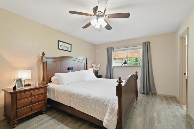 13111 Oak Plaza Dr, Cypress, TX 77429 - bedroom featuring light wood-style floors, ceiling fan, and baseboards