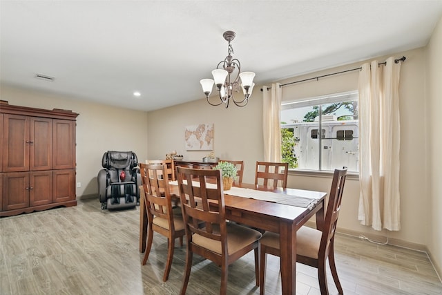 13111 Oak Plaza Dr, Cypress, TX 77429 - dining room with light wood-style flooring, a chandelier, recessed lighting, and baseboards