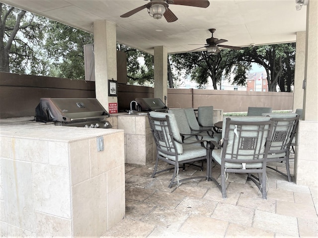 3525 Sage Rd Unit 404, Houston, TX 77056 - view of patio / terrace with outdoor dining space, fence, area for grilling, an outdoor kitchen, and ceiling fan