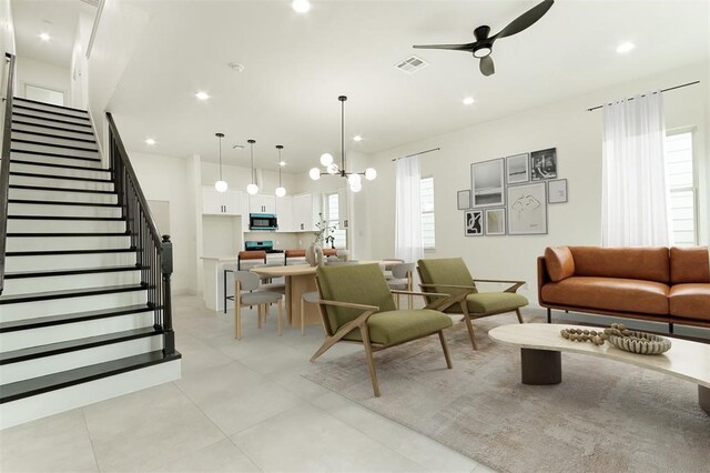 4008 Bennington St, Houston, TX 77016 - living area featuring ceiling fan, stairs, recessed lighting, a chandelier, and light tile patterned flooring