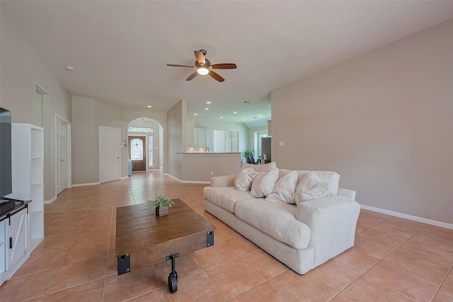 21122 Lilac Meadows Ln, Richmond, TX 77407 - living area with ceiling fan, light tile patterned floors, arched walkways, baseboards, and recessed lighting
