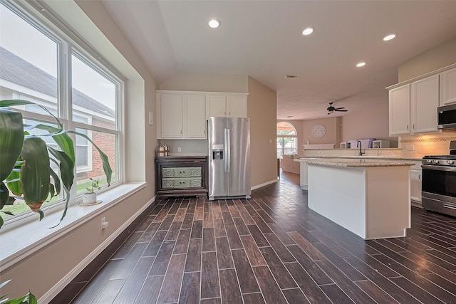 21122 Lilac Meadows Ln, Richmond, TX 77407 - kitchen with appliances with stainless steel finishes, white cabinets, recessed lighting, dark wood-style floors, and lofted ceiling