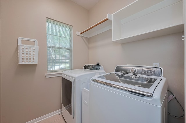 21122 Lilac Meadows Ln, Richmond, TX 77407 - laundry room with washing machine and clothes dryer, baseboards, and light tile patterned floors