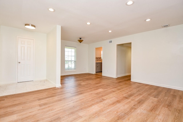 500 N Post Oak Ln, Houston, TX 77024 - spare room featuring recessed lighting, light wood-type flooring, and baseboards
