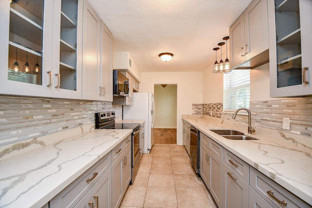 500 N Post Oak Ln, Houston, TX 77024 - kitchen with stainless steel electric range, a sink, black microwave, dishwashing machine, and decorative backsplash