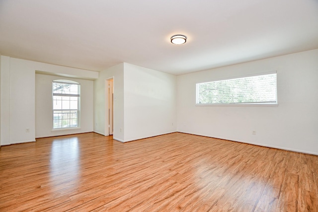 500 N Post Oak Ln, Houston, TX 77024 - empty room with light wood finished floors, plenty of natural light, and baseboards