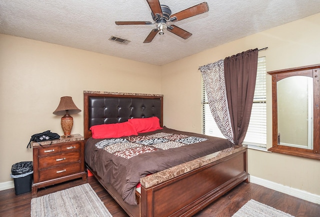 130 Ben Dr, Houston, TX 77022 - bedroom with baseboards, dark wood finished floors, a textured ceiling, and a ceiling fan