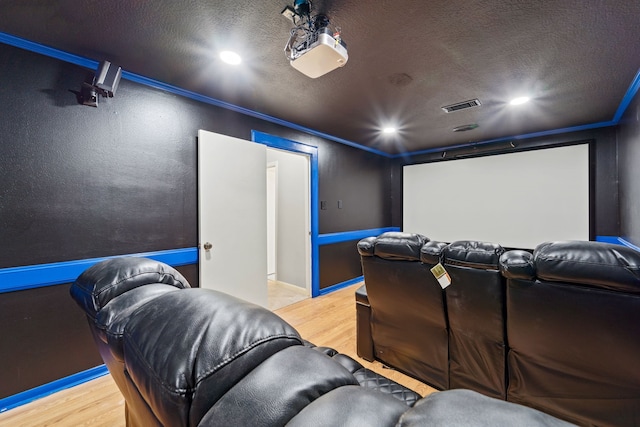 22338 Prince George St, Katy, TX 77449 - home theater featuring wood finished floors, recessed lighting, crown molding, and a textured ceiling