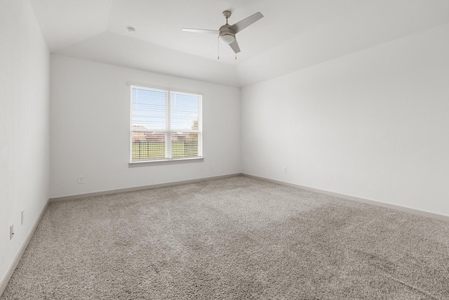 spare room featuring carpet floors, a ceiling fan, and baseboards