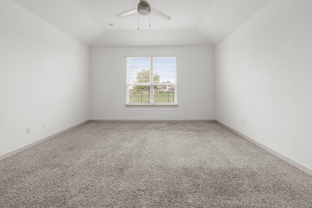 carpeted spare room featuring ceiling fan and lofted ceiling