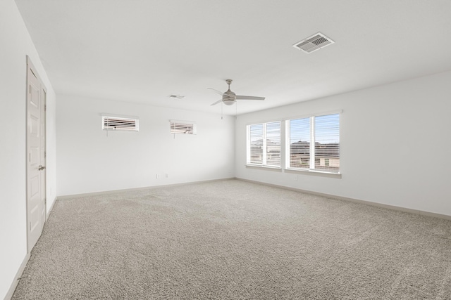 empty room with ceiling fan, carpet flooring, and baseboards