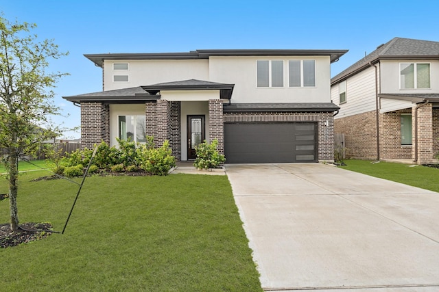 view of front of house featuring stucco siding, an attached garage, brick siding, and driveway