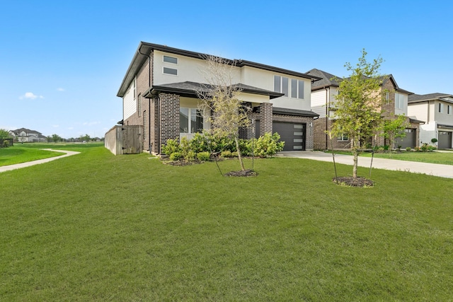 prairie-style house featuring a garage, concrete driveway, brick siding, and a front yard
