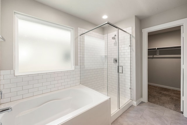 7438 Victoria Brook Trce, Richmond, TX 77407 - full bath featuring a shower stall, a walk in closet, a garden tub, tile patterned floors, and recessed lighting