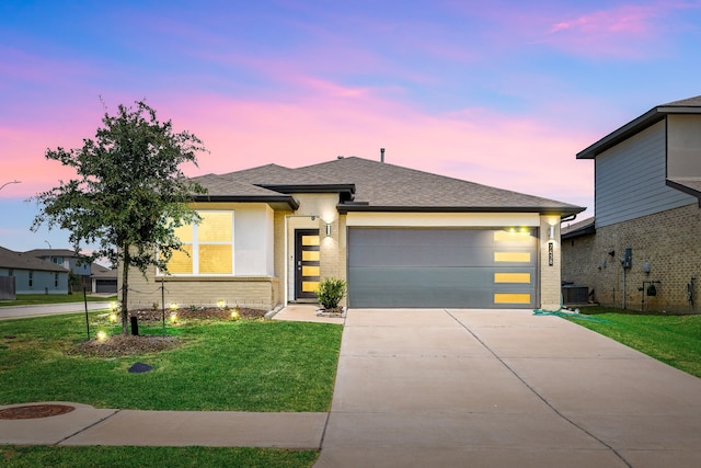7438 Victoria Brook Trce, Richmond, TX 77407 - view of front of home with concrete driveway, a garage, a front lawn, and brick siding