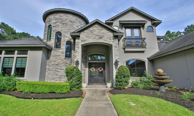 28842 Lakeside Grn, Magnolia, TX 77355 - doorway to property with french doors, stucco siding, stone siding, and a balcony