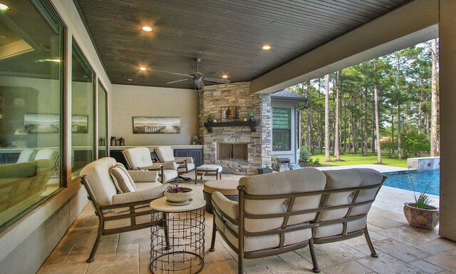 28842 Lakeside Grn, Magnolia, TX 77355 - view of patio / terrace with an outdoor living space with a fireplace, ceiling fan, and an outdoor pool