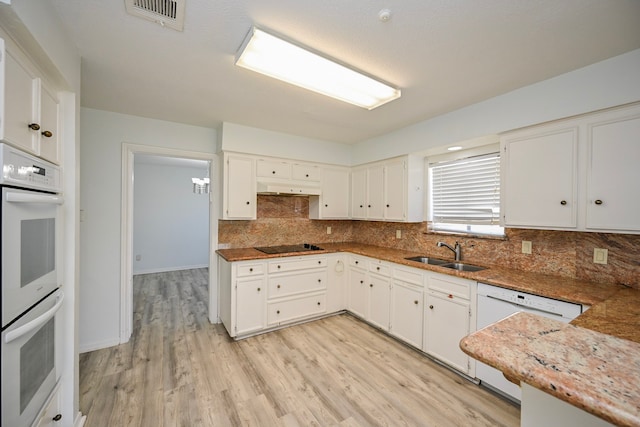 7735 Quail Meadow Dr, Houston, TX 77071 - kitchen with white appliances, decorative backsplash, light wood-style floors, and white cabinetry