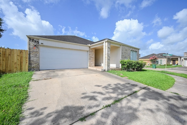 7735 Quail Meadow Dr, Houston, TX 77071 - view of front of home featuring concrete driveway, an attached garage, and stone siding