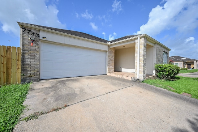 7735 Quail Meadow Dr, Houston, TX 77071 - view of front facade featuring driveway, a garage, stone siding, and brick siding