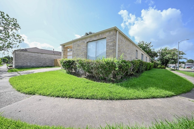 7735 Quail Meadow Dr, Houston, TX 77071 - view of home's exterior with brick siding and a yard